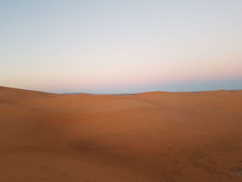 Scenic view of desert against sky during sunset