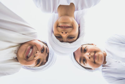 Portrait of smiling boy standing against clear sky