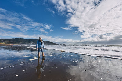 Man standing on beach against sky