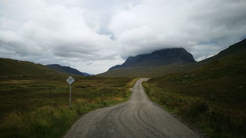 Road amidst mountains against sky