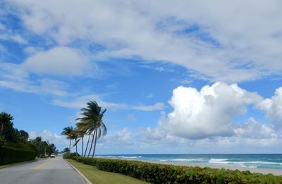 Road by sea against sky