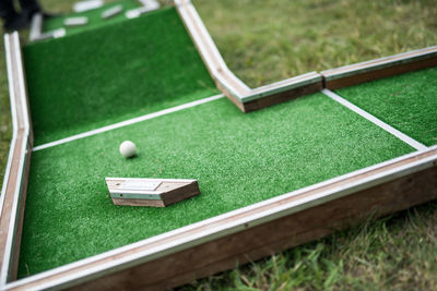 Tilt shot of miniature golf at back yard