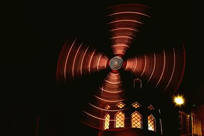 Illuminated tunnel at night