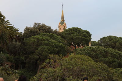 Temple amidst trees and building against sky