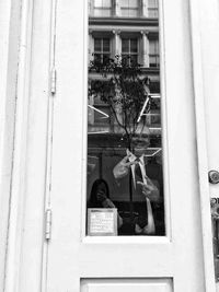 Low angle view of building seen through window