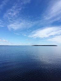 Scenic view of sea against blue sky