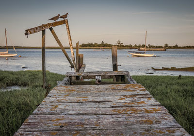 Abandoned ship in sea against sky