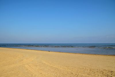 Sea side sandy beach against sea and blue sky on the summer 