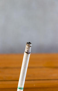 Close-up of lit cigarette outdoors