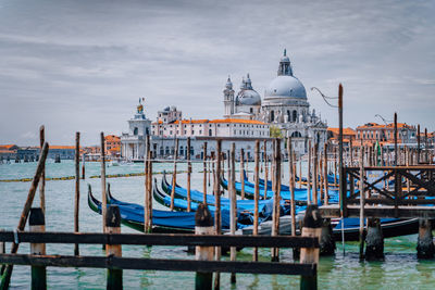 Boats moored in canal against santa maria della salute