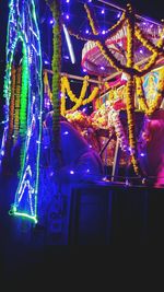 Low angle view of illuminated lights at night