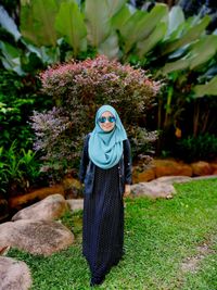 Portrait of woman in hijab standing on field