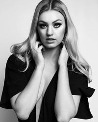 Portrait of young woman against white background