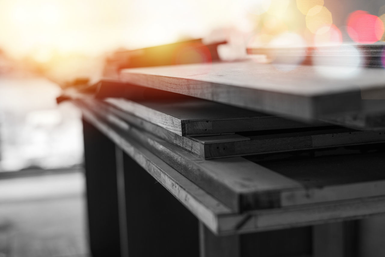 CLOSE-UP OF BOOKS ON WOODEN TABLE