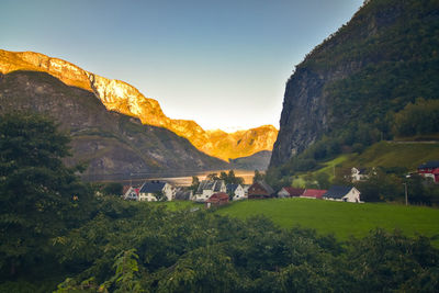 Scenic view of houses and mountains against sky