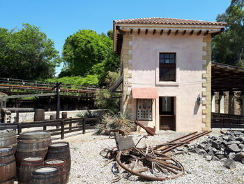 Exterior of old building by trees against sky