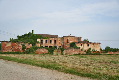 Old building on field against sky