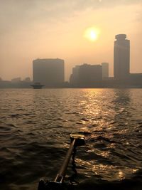 City at waterfront during sunset