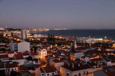 Aerial view of city lit up at seaside