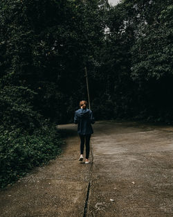 Rear view of man standing in forest