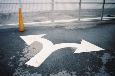 High angle view of arrow sign on road