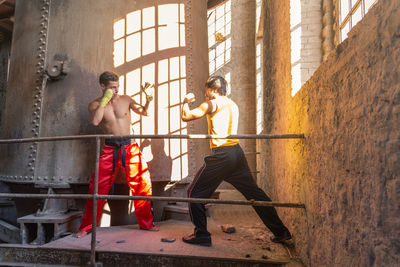 Men boxing at construction site