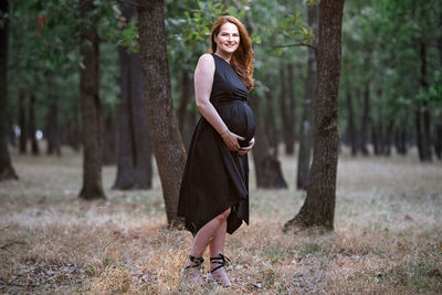 Full length portrait of woman in forest