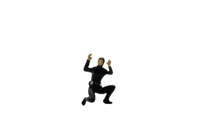 Man with arms raised against white background
