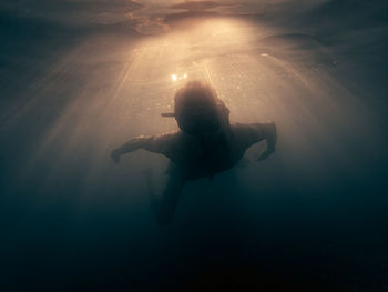 Man swimming diving in ocean