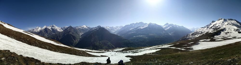 Scenic view of snow covered mountains against sky