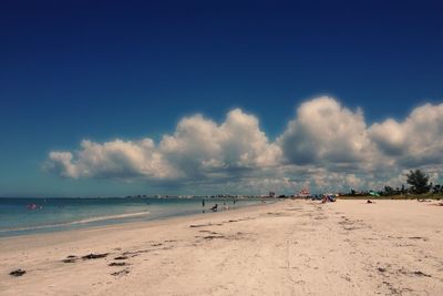 Scenic view of beach against blue sky