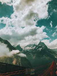 Low angle view of mountain against cloudy sky