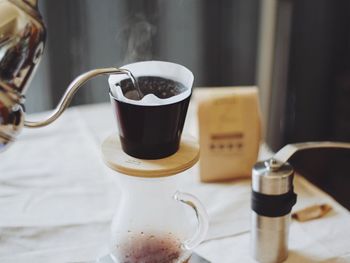 Hot water being poured in coffee filter on table