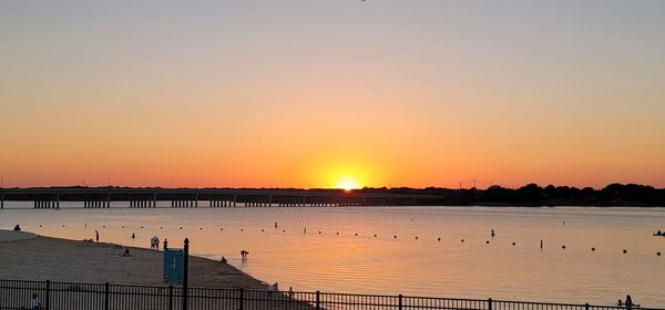 Scenic view of lake against romantic sky at sunset