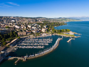 High angle view of city by sea against sky