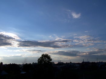 Silhouette of building against cloudy sky