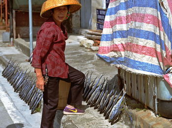 Full length of a woman standing in city