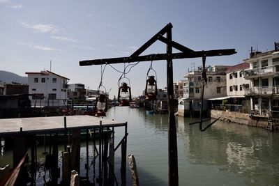 River amidst buildings in city against sky