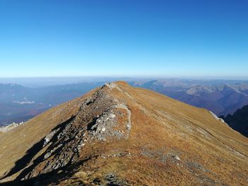 Scenic view of mountains against clear blue sky