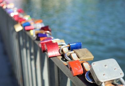 Close-up of love locks on bridge over river