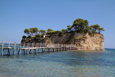 Pier over sea against clear sky