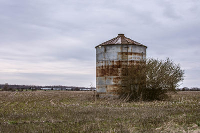 Abandoned structure on field against sky