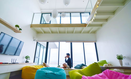 Low angle view of people on sofa at home