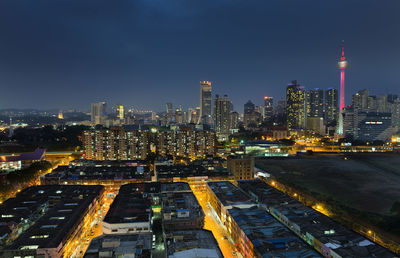 Menara kuala lumpur tower with cityscape against sky at dusk