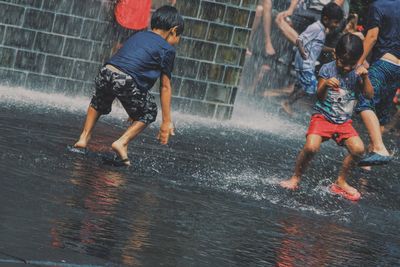 Blurred motion of man playing fountain