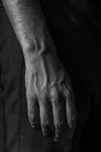 Close-up of hands against black background