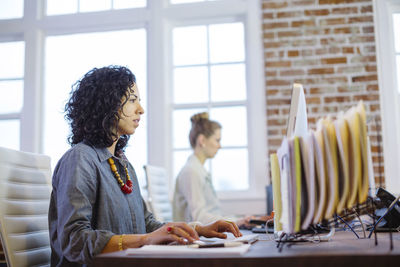 Female colleagues working at desk in office