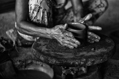 Midsection of potter working in workshop