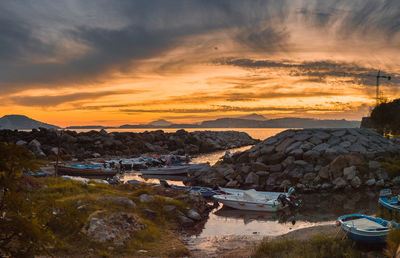 Scenic view of harbor against sky during sunset