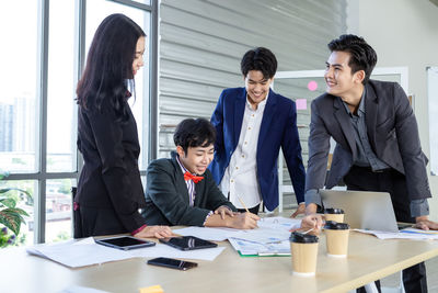 Group of people using mobile phone at table